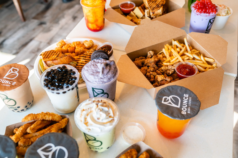 Boba drinks with popcorn chicken, seasoned fries and snacks at Bounce Boba Lounge